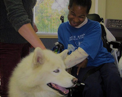 handicapped child visiting with white dog