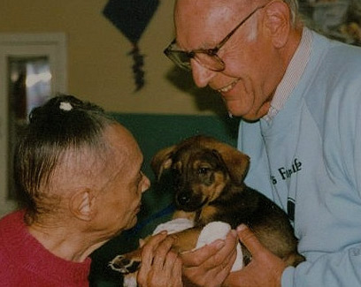 elderly folks with a puppy