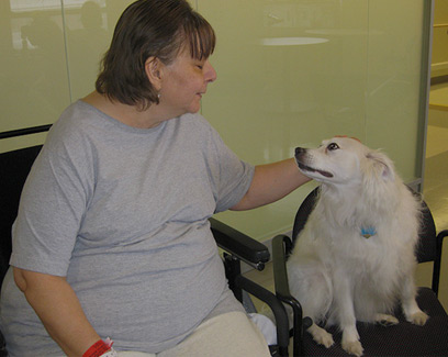 woman petting white dog